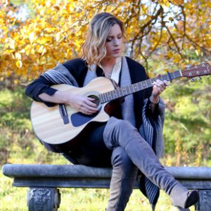 Mary McAvoy, playing guitar.